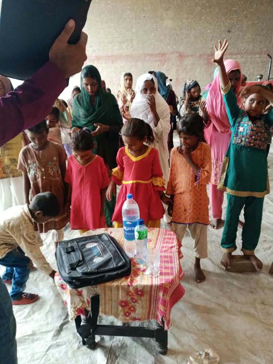 A photograph sent from the ministry in Pakistan: children and families gathered outdoors