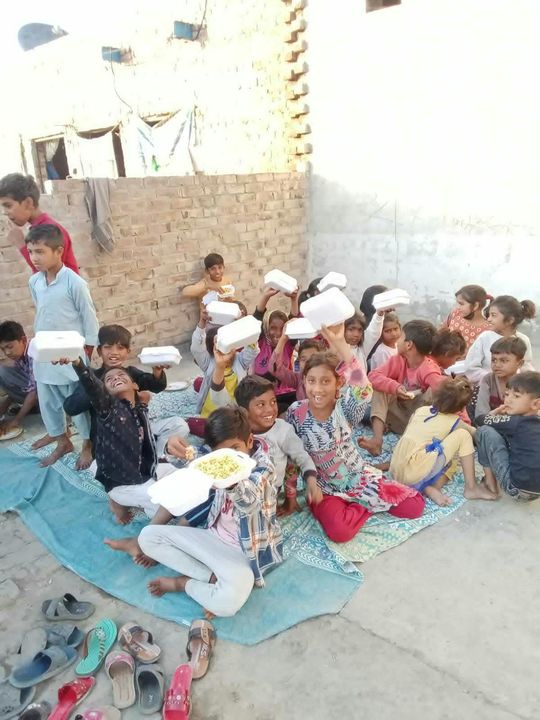 A photograph sent from the ministry in Pakistan: children and families gathered outdoors