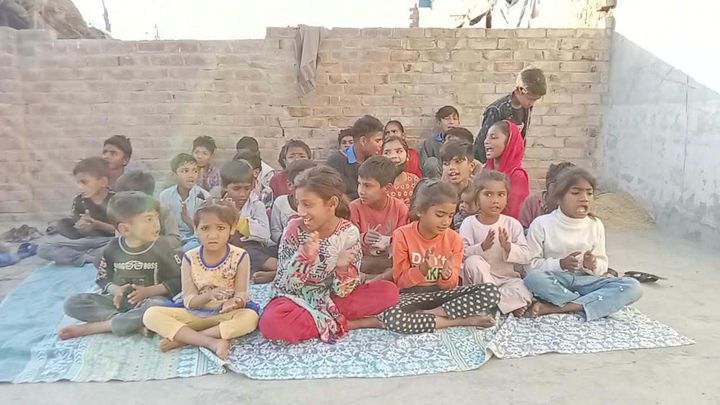 A photograph sent from the ministry in Pakistan: children and families gathered outdoors